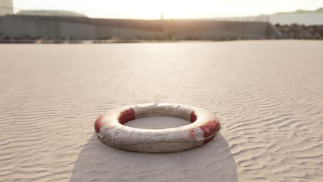 lifebuoy on the city beach at sunset