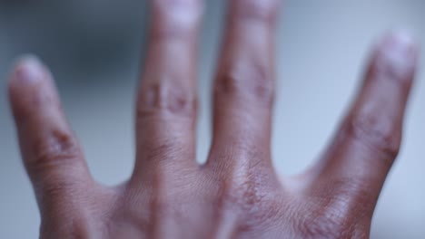 moving hand on a bokeh nature backdrop. selective focus shot