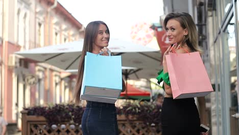 two happy young girls are shopping clothes in a department store two happy young girls are shopping clothes in a department store