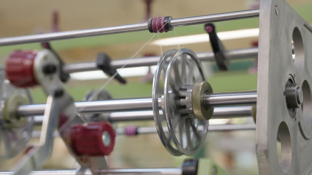 Loom machine in action, showcasing threads, moving parts, and the weaving process, ideal for textile manufacturing, craftsmanship, industrial production, and machinery visuals