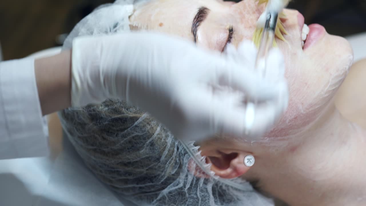 Woman receiving facial treatment