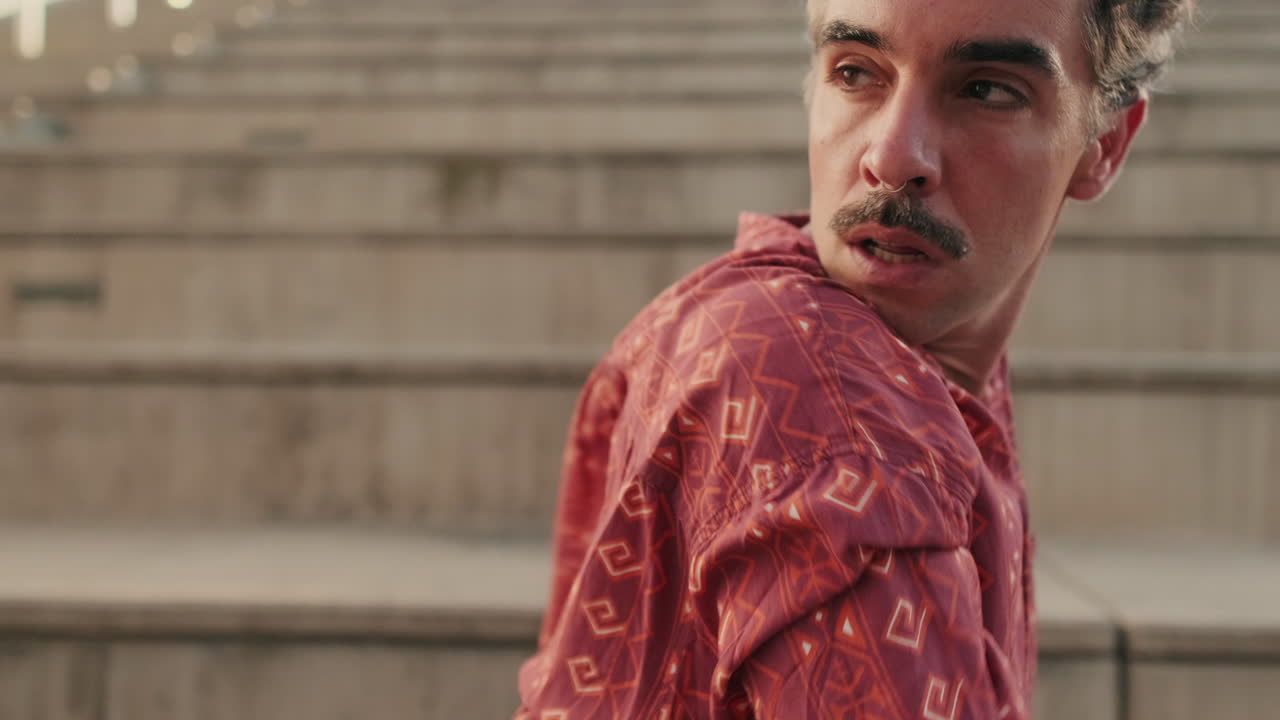 Artistic Young Man Performing Expressive Dance on Urban Steps