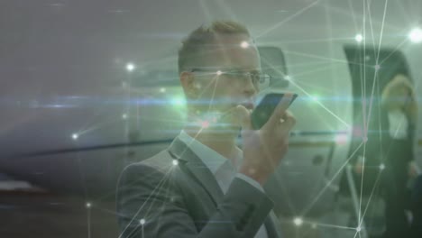 Animation-of-data-processing-over-caucasian-businessman-using-smartphone