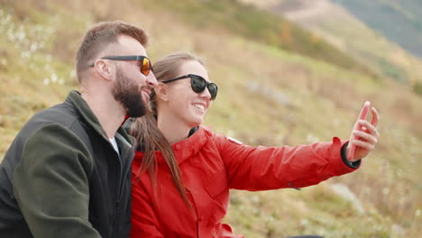 couple taking selfie in autumn mountains