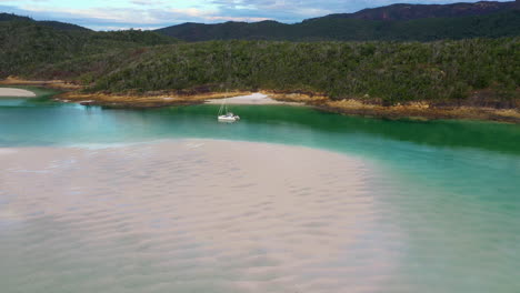 drone shot of sailboat in water at whitehaven beach whitsunday island australia