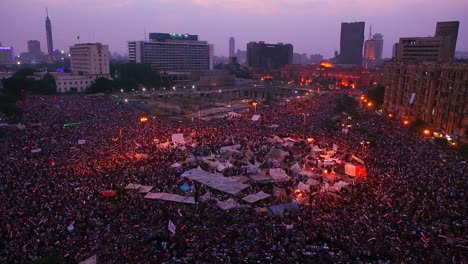 fireworks go off above protestors gathered in tahrir square in cairo egypt as dawn breaks 1