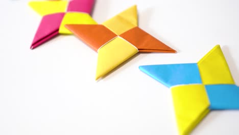 DIY-origami-darts-game,-flighting-colorful-ninja-star,-childhood-memory