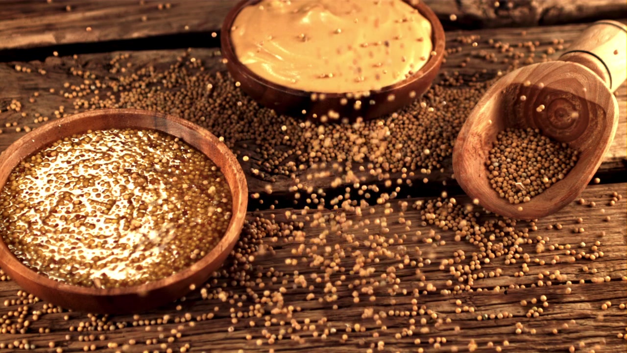Mustard Seeds Falling in Slow Motion with Bowls on Wooden Table