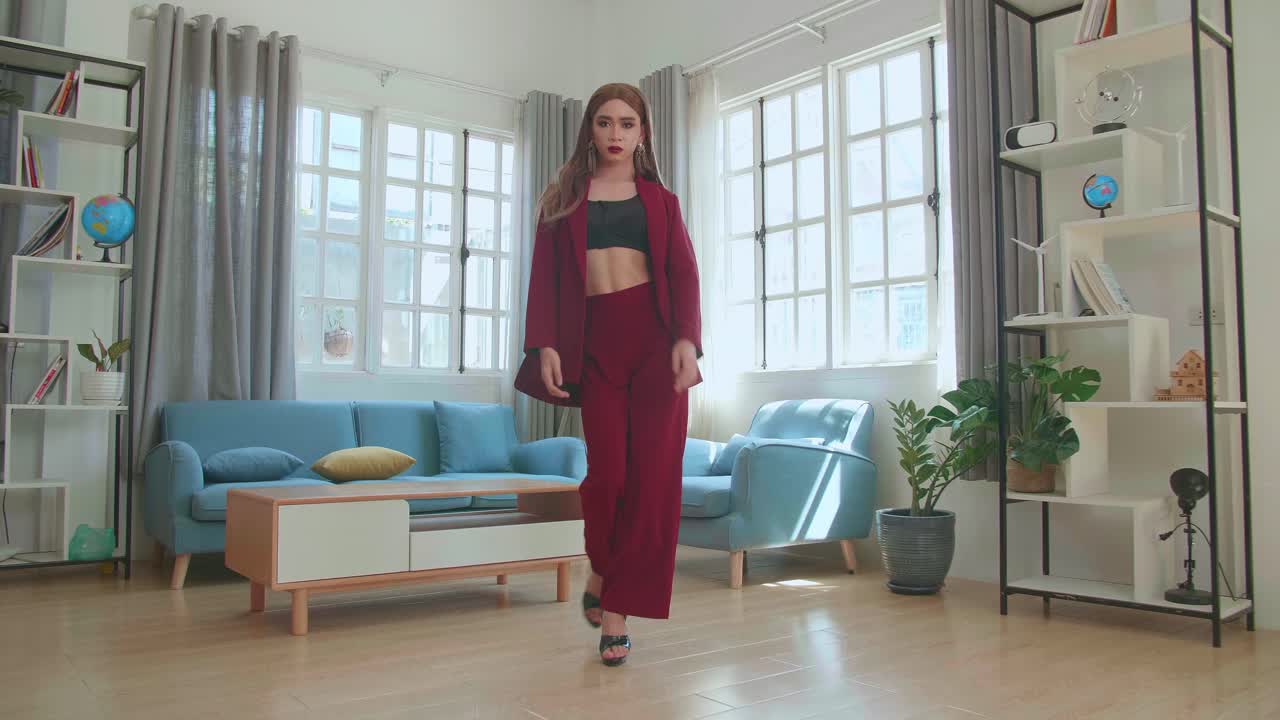 Young Fashion Transgender Woman Wearing Red Clothes Walking And Posing In Home
