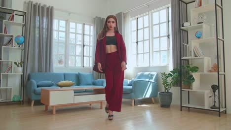 young fashion transgender woman wearing red clothes walking and posing in home