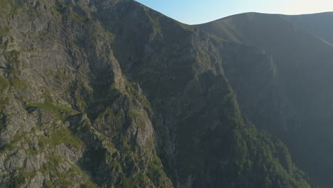 aerial reveal of mountain cliff with birds eye view