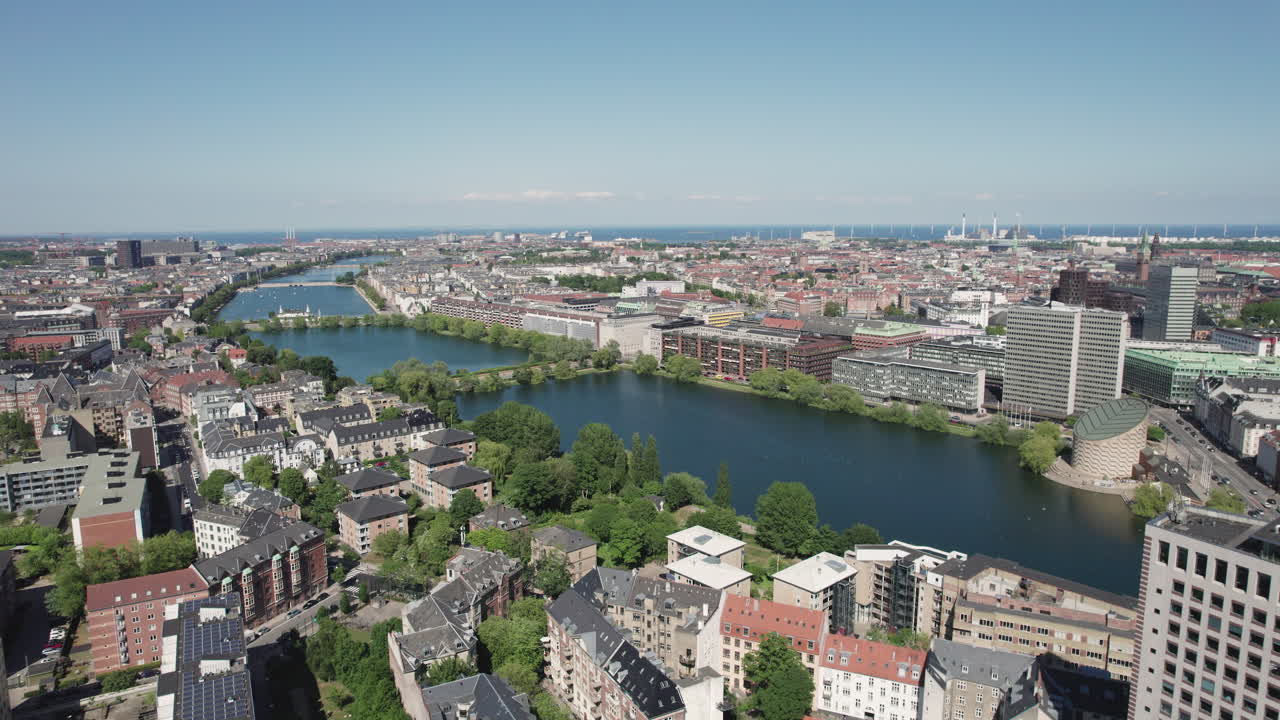 Experience the splendor of Copenhagen from above as you take in the breathtaking aerial view of its beautiful lakes, which unveil the city's dynamic center and skyline with office buildings