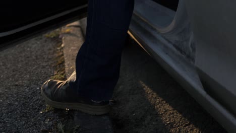 car door opens with feet getting out car medium shot