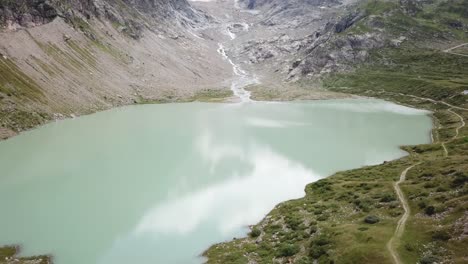 High-Drone-flight-over-Lake-and-Stein-Glacier-in-the-Urner-Alps-in-Switzerland