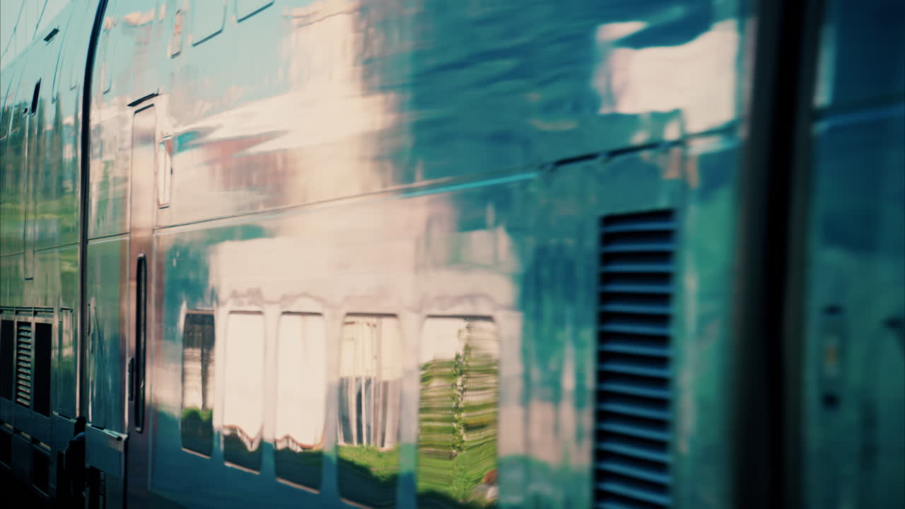 Close up of a blue train moving on the rails near a station in France