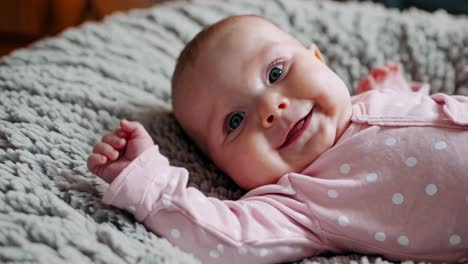 smiling baby girl in pink outfit