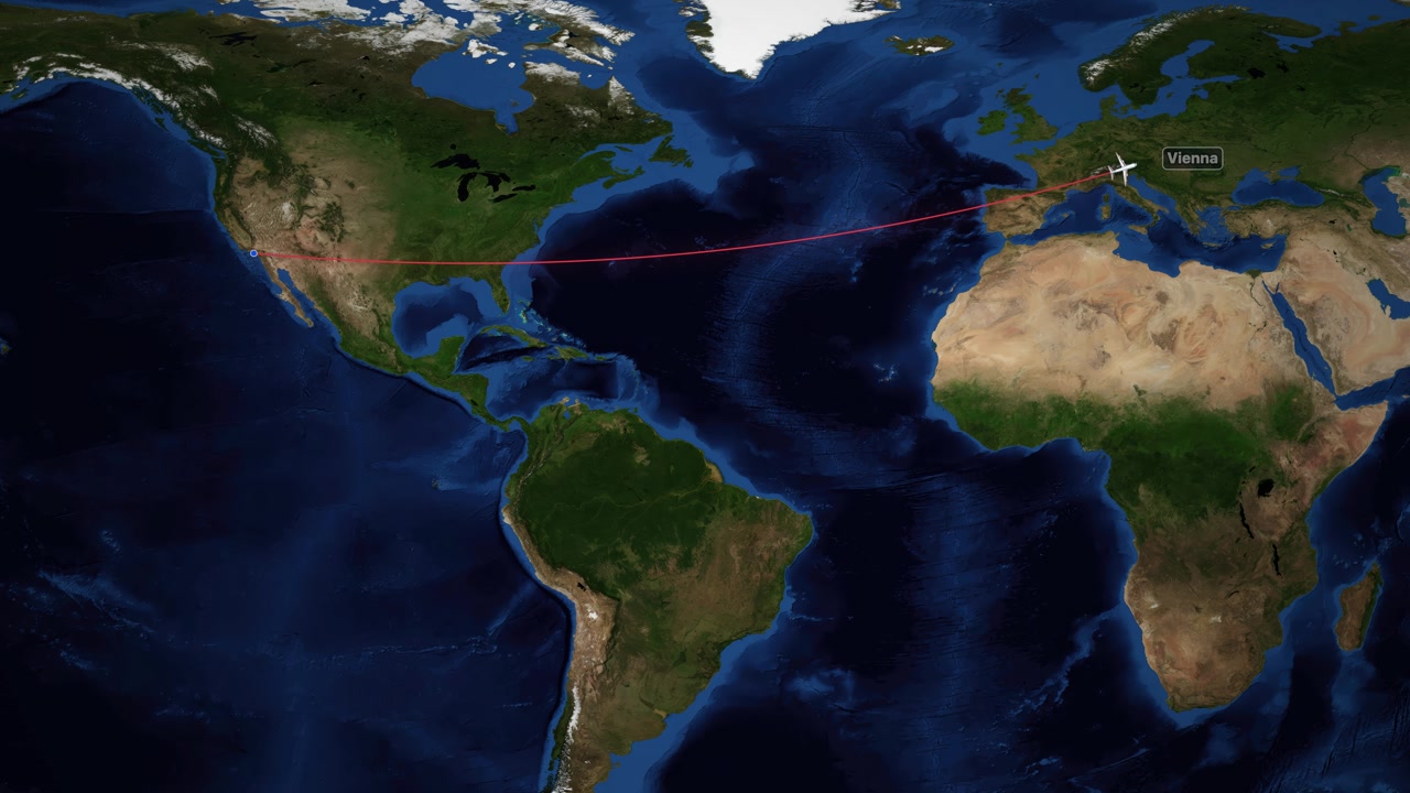 Una línea roja traza un avión volando a través del Océano Atlántico en un mapamundi