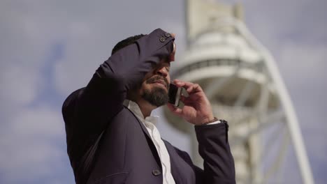 angry businessman gesturing and talking by cell phone