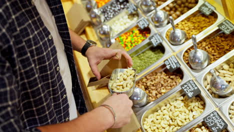 person buying nuts at a grocery store