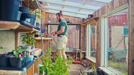 norwegian man inside the greenhouse with mirror wall. static shot