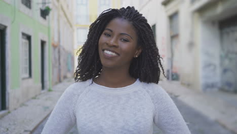 Beautiful-young-woman-with-dreadlocks-looking-at-camera