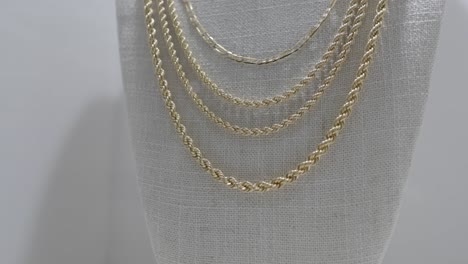 closeup of gold rope chain necklace in different sizes