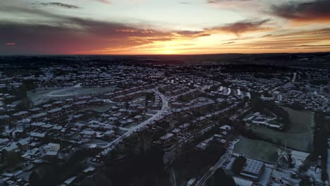 yorkshire winters morning dawn aerial scene showing rural housing and frost covered rooftops with morning sun breaking through the clouds