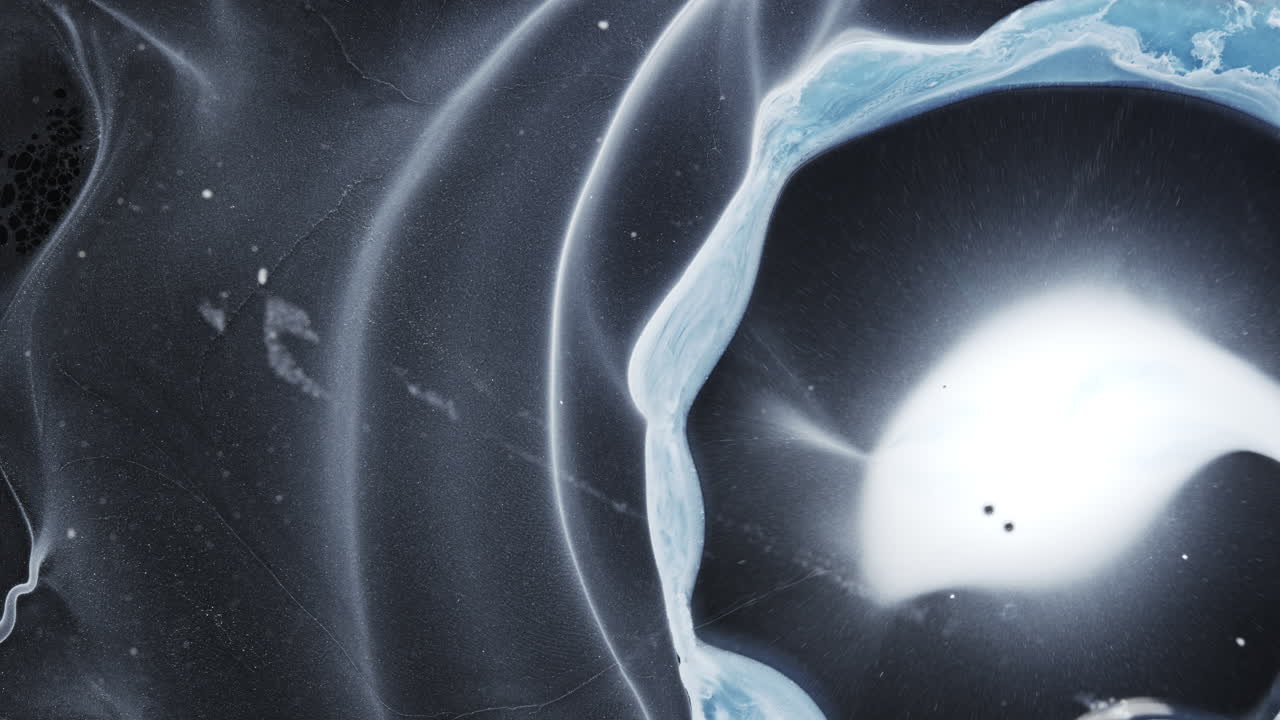 Ink mixing with a unique blend of colors in a dynamic abstract composition