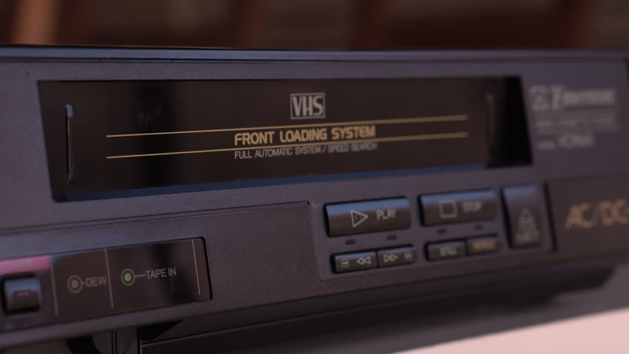 Inserting VHS Video Tape in VCR Player, Close Up