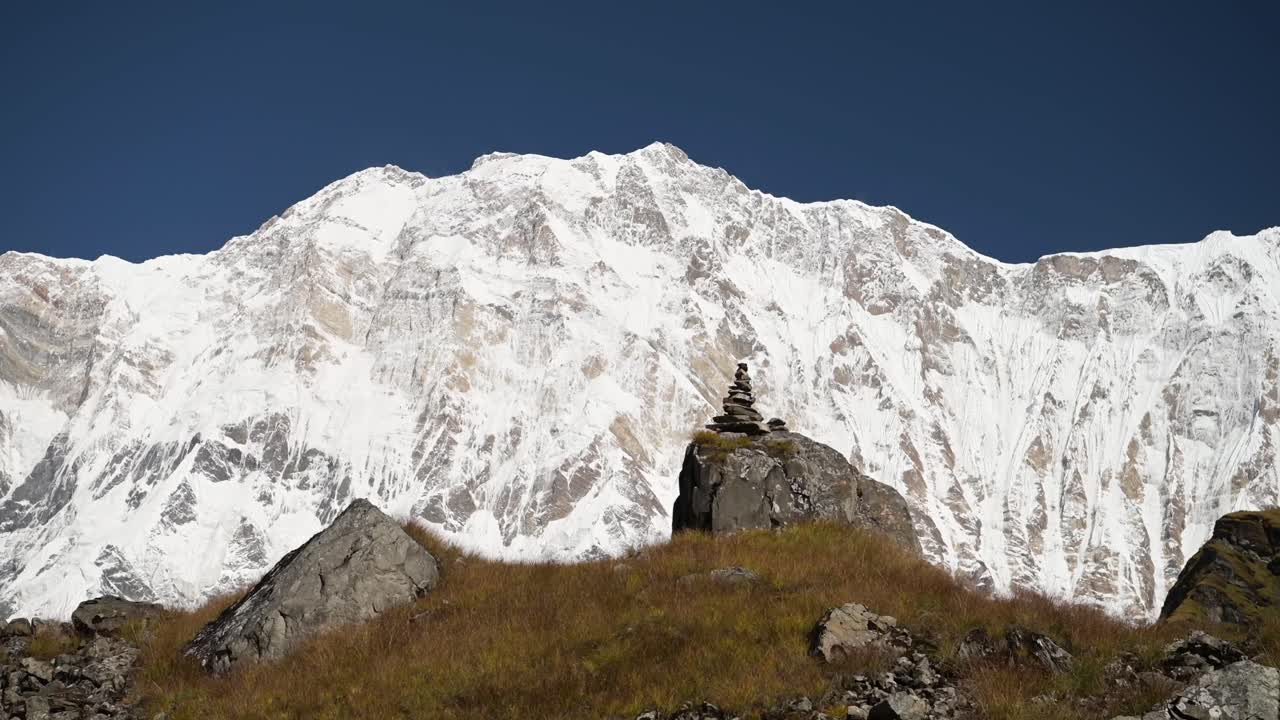 Balancing Stones in Snowcapped Mountains Background with Copy Space, Art of Meditation in Stone Balancing in Beautiful Mountain Scenery, Meditating Background with Copyspace