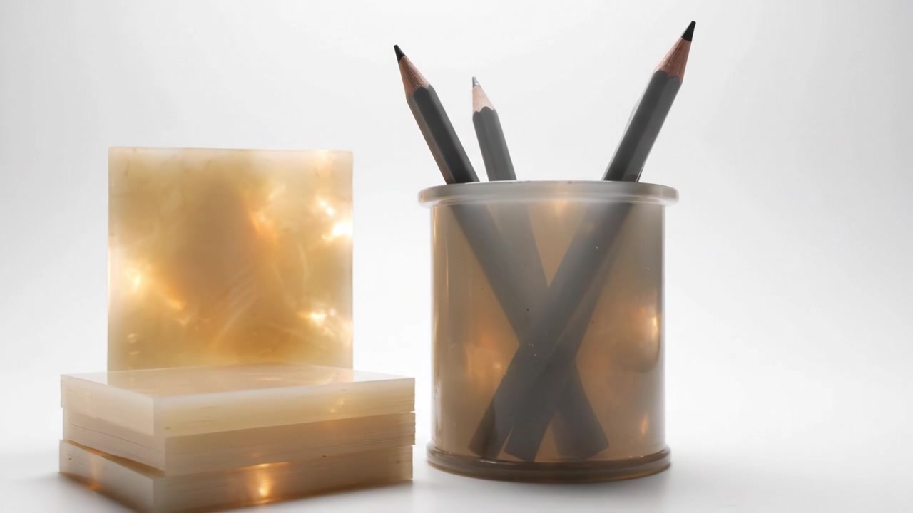 Aesthetic Display of Stationery Items with Pencils in a Transparent Holder and Soft Light Setting, Highlighting Minimalist Design Elements