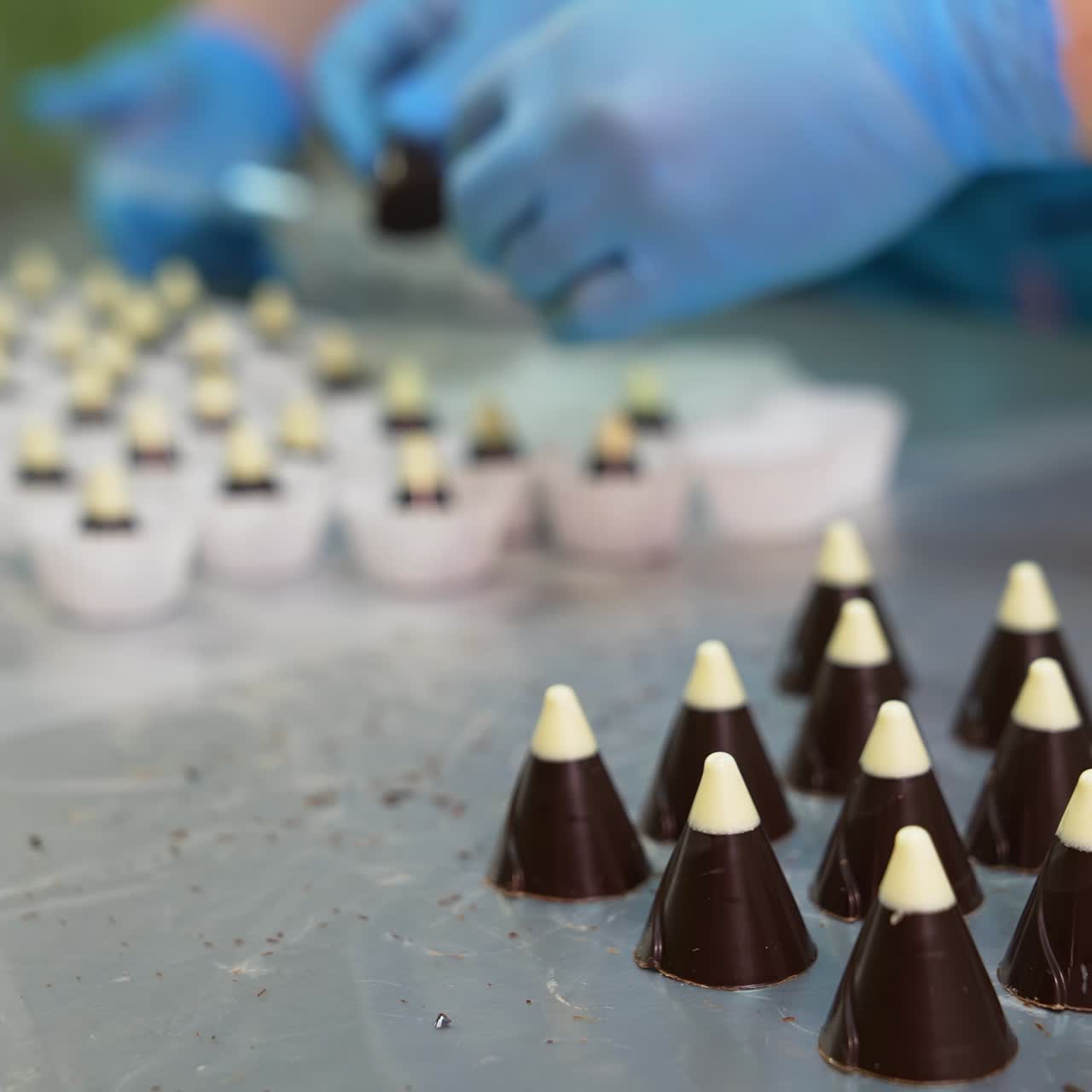 Professional confectioner prepairing sweet candies. Pastry making cake proccess