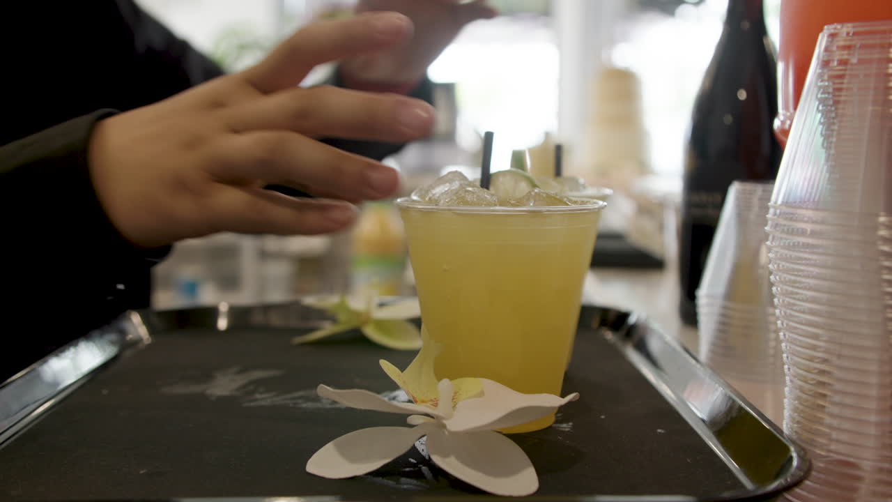 setting out yellow mixed drinks at a bar