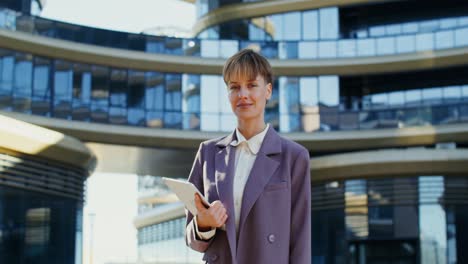 business woman with tablet in front of modern building