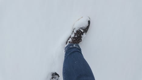 pov of a person walking in deep snow landscape during winter season