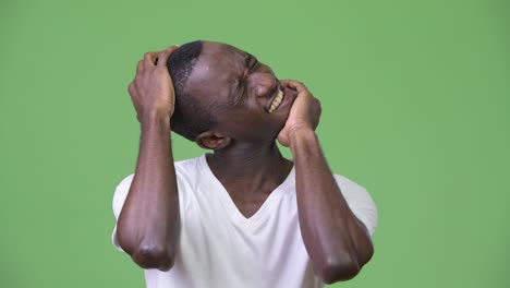 young african man having neck pain and cracking neck