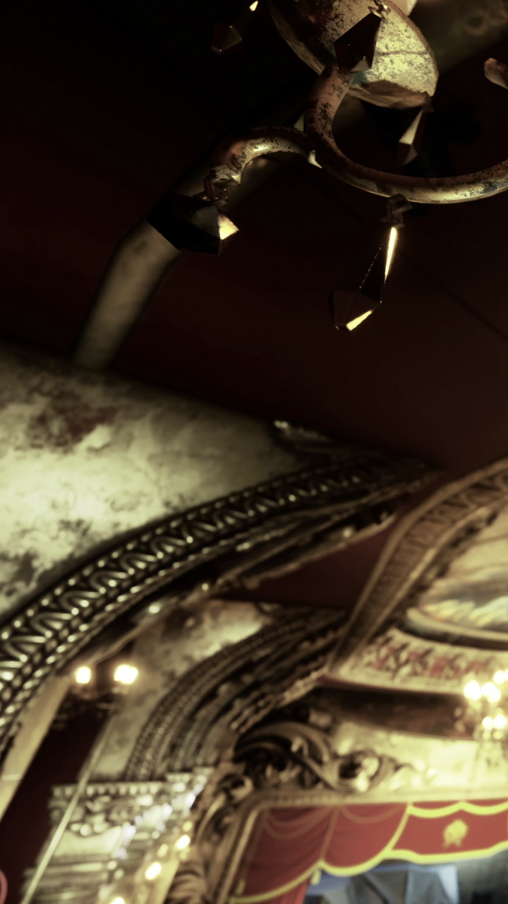 Decorative ceiling and chandelier in a historic theater setting