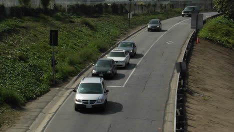 Traffic-stops-at-a-light-on-a-narrow-access-road-then-proceeds