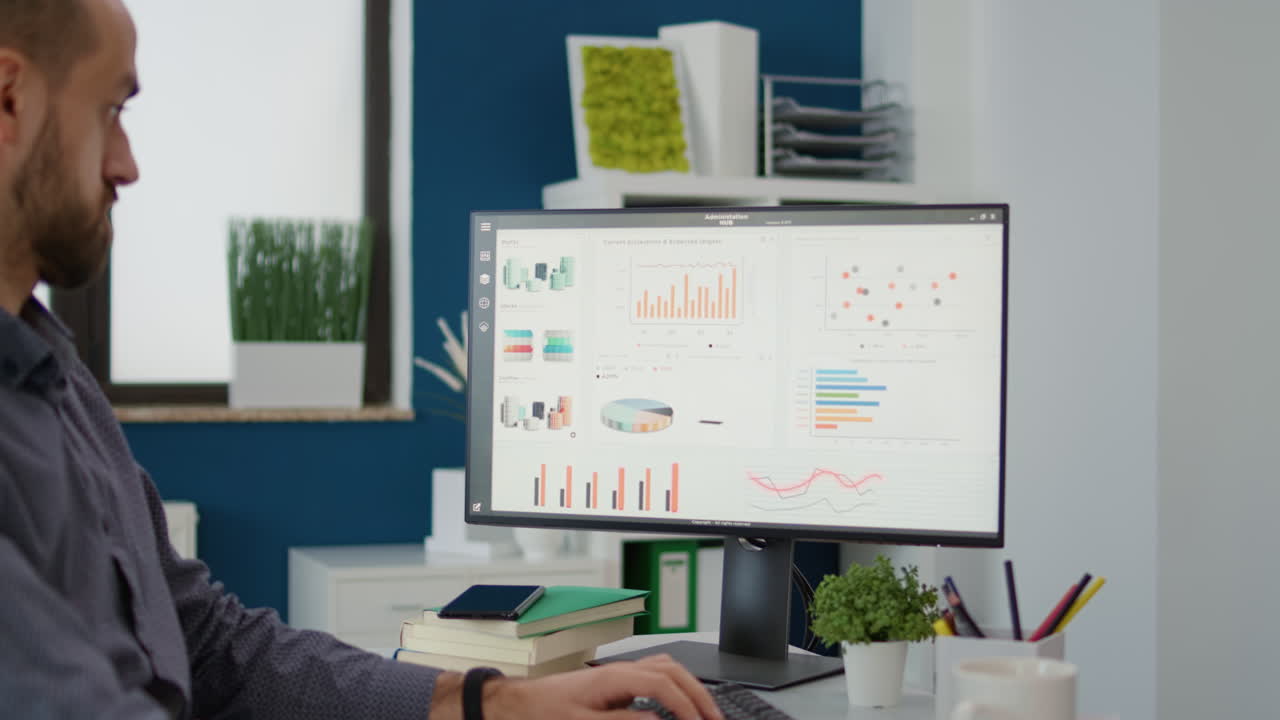 Project manager analyzing business sales charts on computer