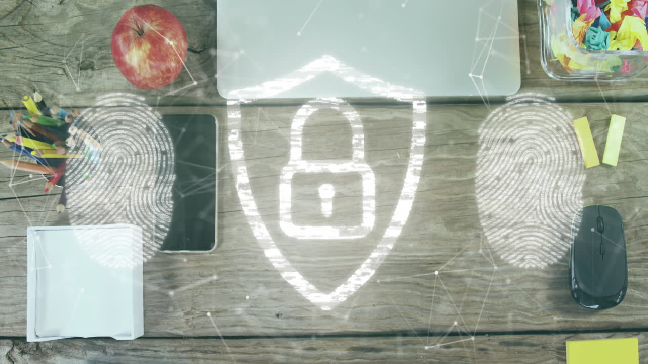 Animation of security padlock icon and fingerprint scanner over office equipment on wooden surface