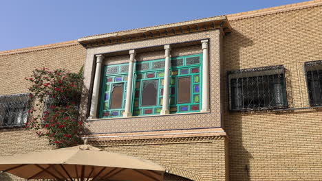 Casa-Tradicional-De-Sbeitla-Con-Ventanas-Ornamentadas-Y-Ladrillos,-Cielo-Azul