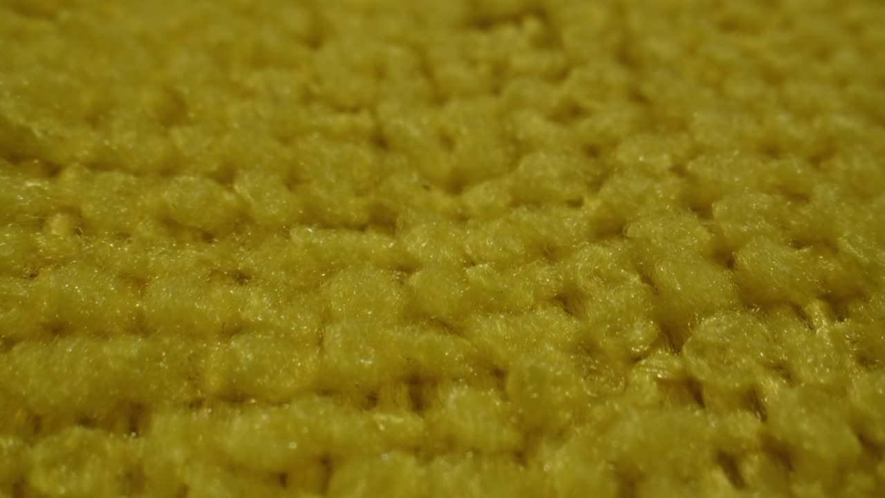 Detailed Macro View of Soft Yellow Fabric Texture