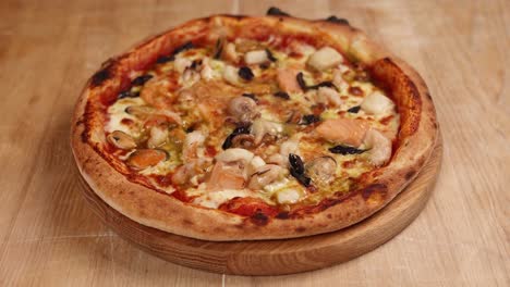 seafood pizza being prepared by a chef