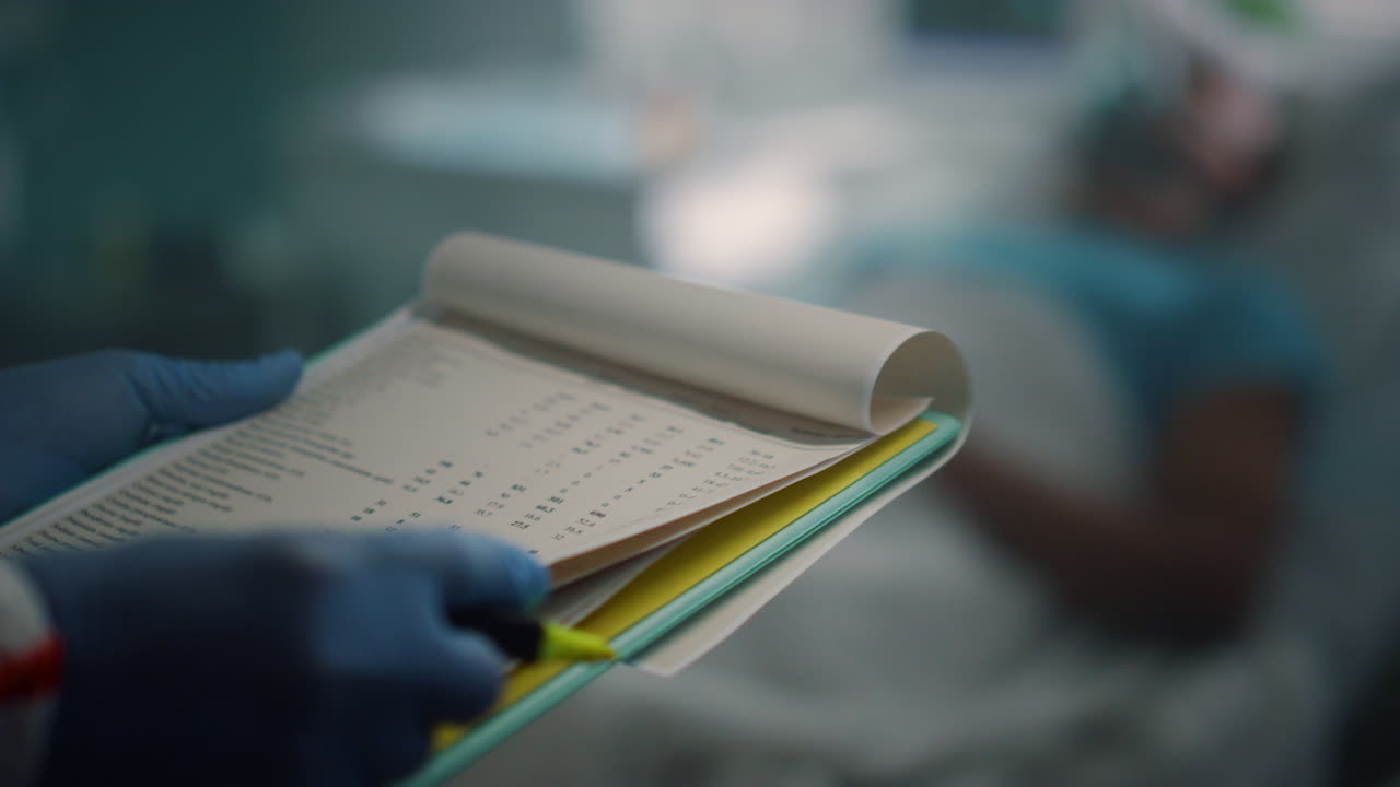 Nurse hands making notes holding clipboard in hospital infectious unit close up.