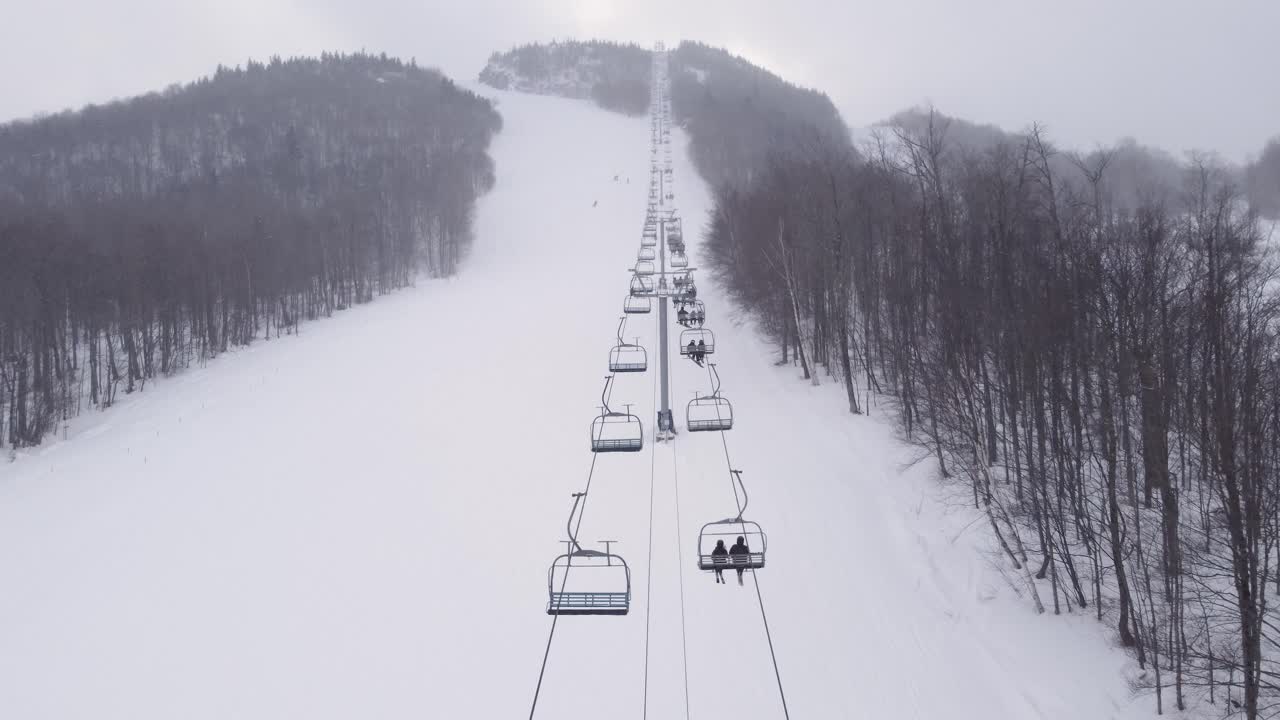 close-up from above of the ski lift carrying skiers to the top of the hill in Quebec, Canada