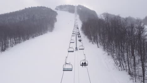 close-up from above of the ski lift carrying skiers to the top of the hill in quebec, canada