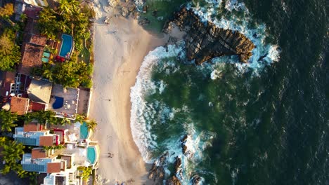 top down view of beautiful white sand rocky beach at playa amapas in puerto vallarta mexico at sunset, aerial