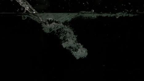 water pouring into pool on black background