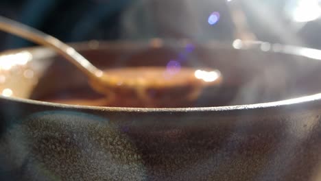 steaming bowl of soup with a spoon