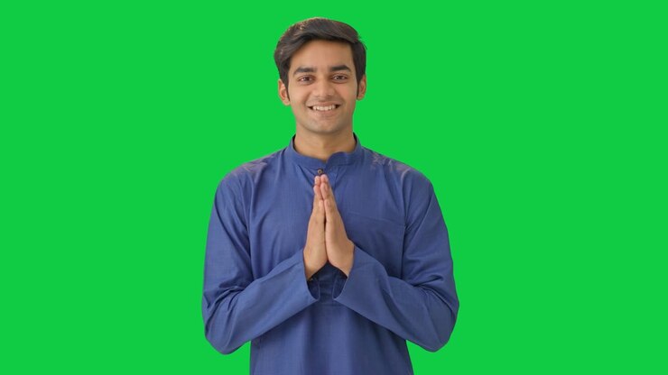 Indian boy doing namaste and greetings Green screen